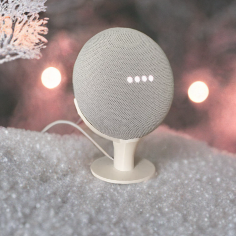 A Google Home Nest Mini sat in a upright stand.