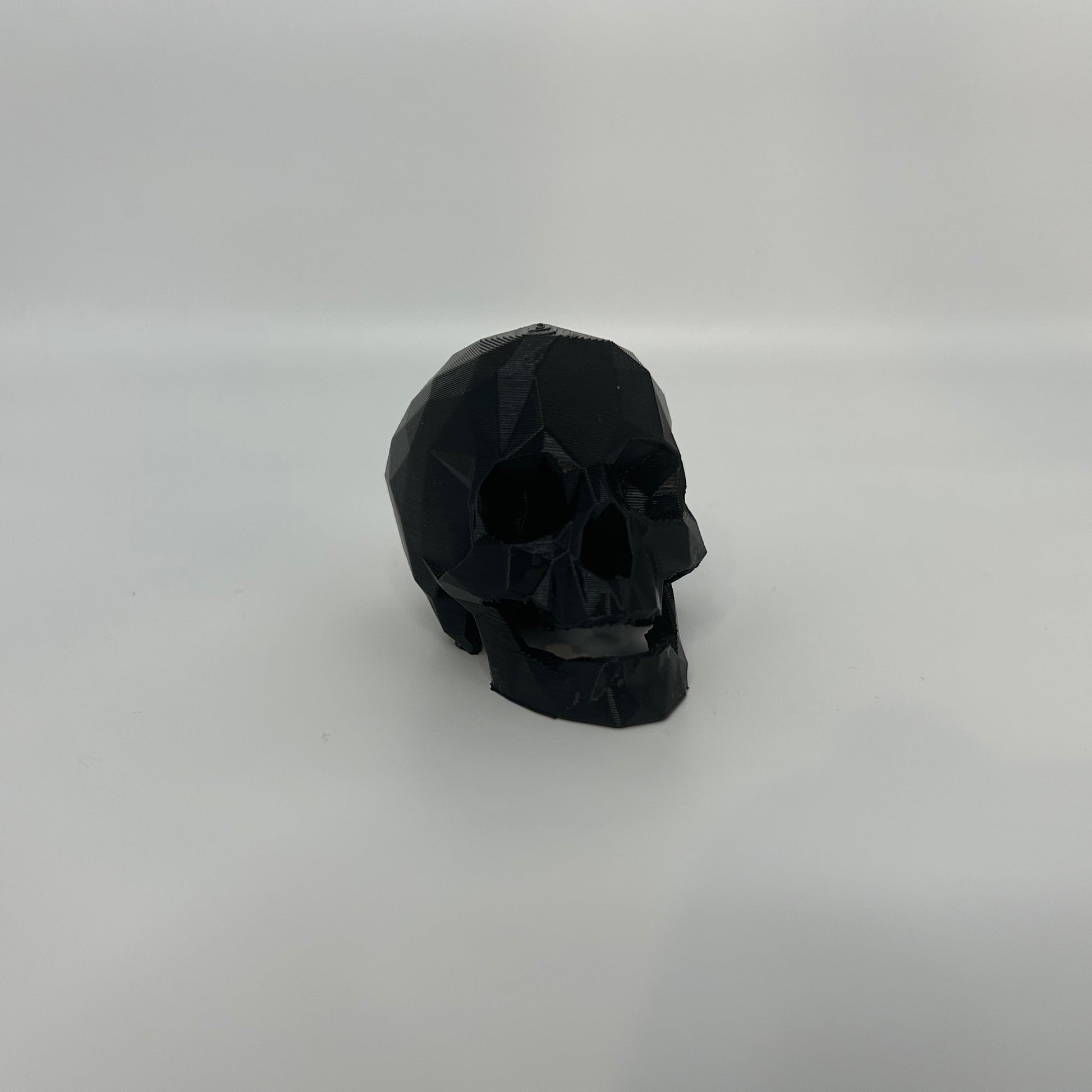 Small low poly black skull